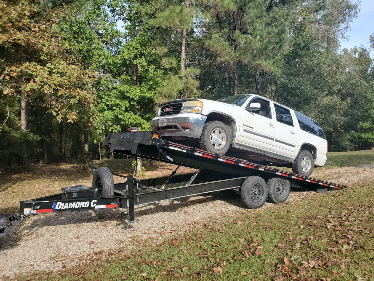 22ft Thing 1 Diamond C equipment trailer rental Coldspring TX - 10000 lb hydraulic tilt deckover with electric winch